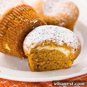 Spiced Pumpkin Cream Cheese Swirl Muffins 4 Perfectly baked Pumpkin Cream Cheese Muffins, ready to enjoy.