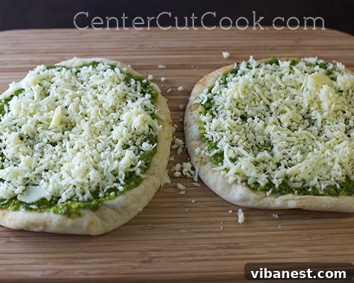Provolone cheese on flatbread Shredded provolone cheese generously topping a pesto flatbread