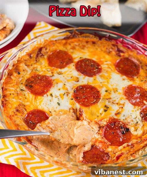 Pizza Dip with Dippers Close-up of baked pizza dip with melted cheese and pepperoni, accompanied by bread dippers.