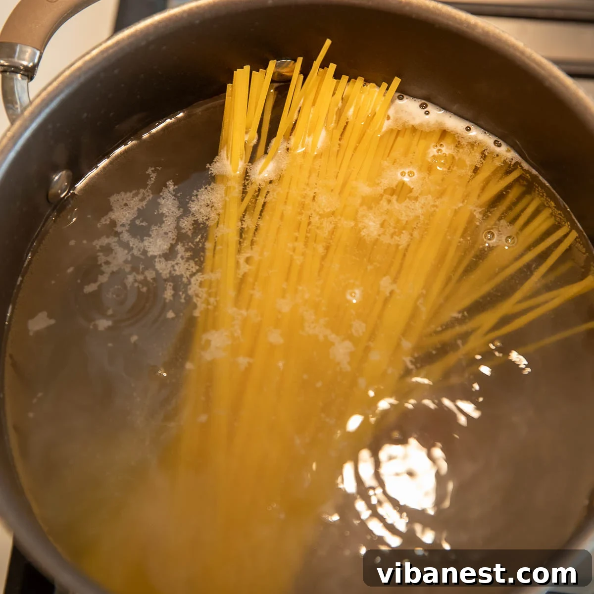 Lemon Garlic Shrimp Linguine 5 Linguini pasta gently boiling in a large pot of salted water, preparing for the delicious shrimp scampi pasta dish.
