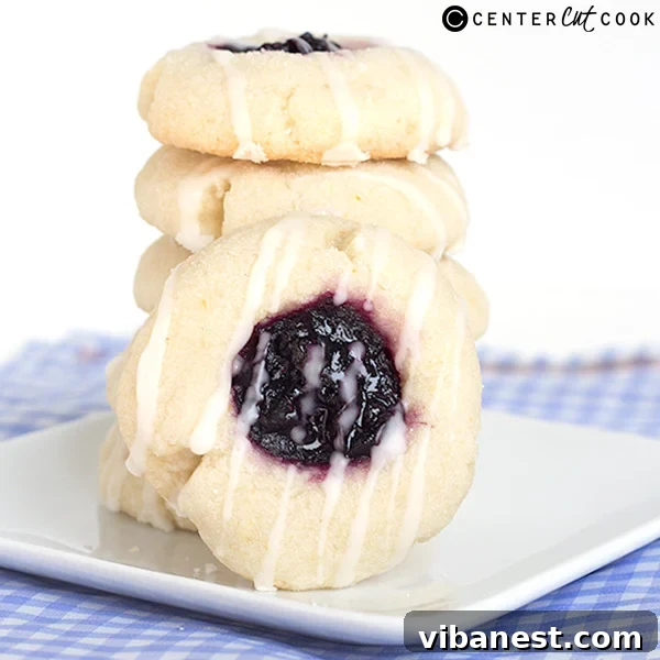 blueberry-lemon-thumbprint-cookies-4.jpg Tray of freshly baked Blueberry Lemon Thumbprint Cookies with elegant glaze drizzle