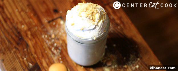 Delicious Banana Cream Pie Smoothie ready to be enjoyed, garnished with whipped cream and crushed vanilla wafers.