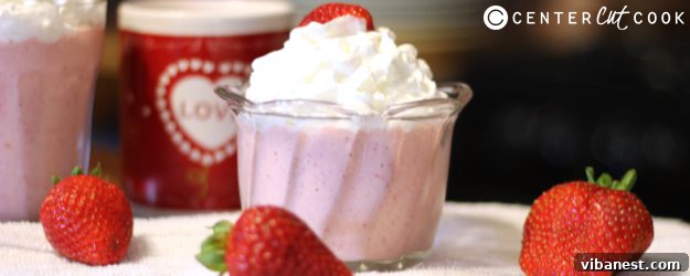 Delicious and creamy strawberry shortcake smoothie in a glass jar, garnished with fresh strawberries