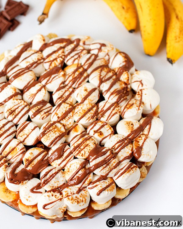 Banoffee S'mores Pizza Serving Serving slice of Banoffee S'mores Pizza on a plate, highlighting layers