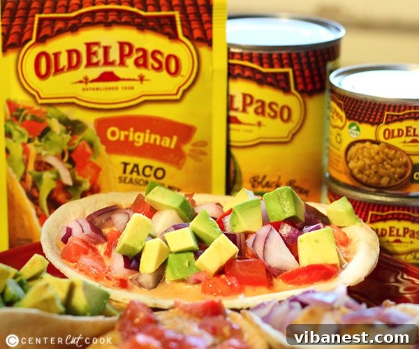 Close-up of fully loaded Chicken Chili Queso Boats with vibrant fresh toppings like avocado and cilantro