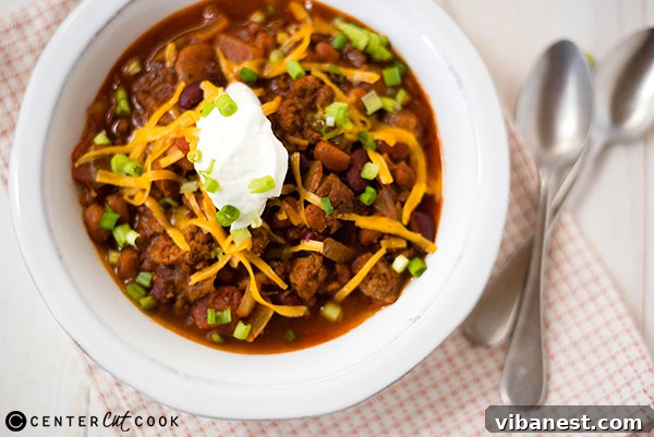 Ground beef browning in a skillet, ready to be added to slow cooker chili