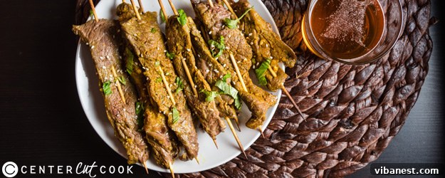 Delicious Thai beef skewers served fresh off the grill with a vibrant dipping sauce