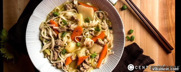 Hearty bowl of Asian Chicken Noodle Soup with fresh herbs and rich broth
