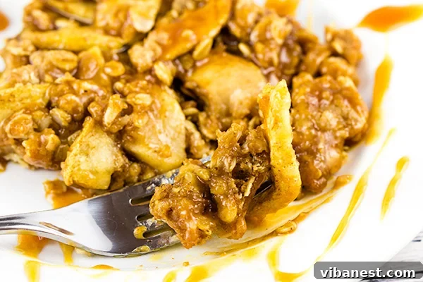 Apple-Pie-Streusel-Bars-with-Caramel Top-down view of Apple Pie Streusel Bars freshly baked and drizzled with caramel, in a baking dish