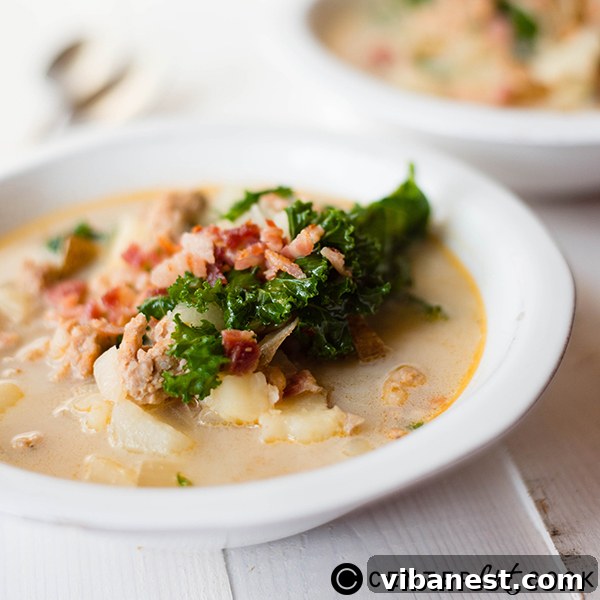 A serving of Olive Garden Zuppa Toscana soup in a rustic bowl with bread