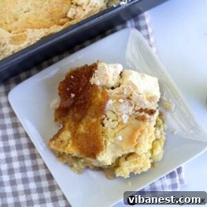 A slice of pear dump cake on a white plate, ready to be enjoyed.