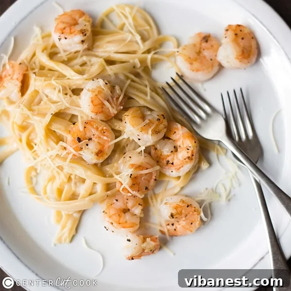 shrimp-fetuccine-alfredo-4.jpg A bowl of creamy Shrimp Fettuccine Alfredo with fresh parsley garnish