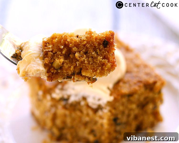 Caramel Crowned Pumpkin Walnut Delight 4 Top-down view of a whole pumpkin walnut cake with a dollop of caramel whipped cream on a slice