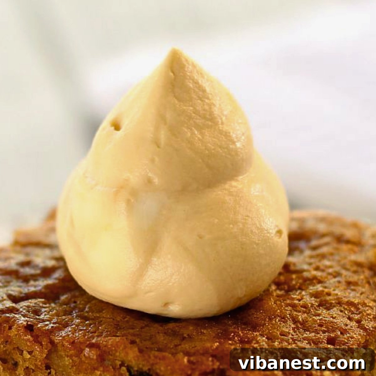 Caramel Crowned Pumpkin Walnut Delight 5 Close-up of homemade caramel whipped cream atop pumpkin walnut cake