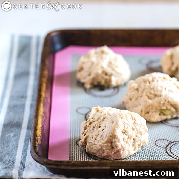 The biscuit dough mixture showing lumps of butter starting to form, indicating the correct consistency before baking.
