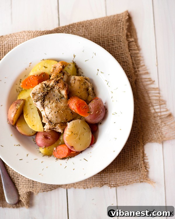 One-pan roasted rosemary chicken with potatoes and carrots, ready to serve