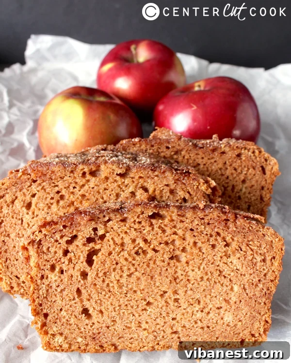 Cinnamon Apple Bread Slice Close-up shot of Cinnamon Apple Bread slice, showing its moist crumb and visible apple pieces