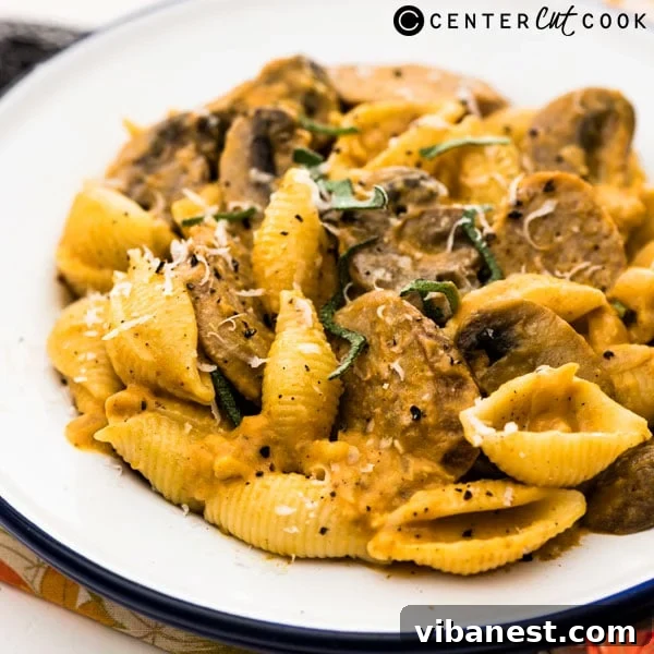 Gourmet Creamy Pumpkin Pasta with Sausage Ready-to-serve pumpkin pasta with sausage, garnished with fresh sage and parmesan