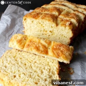 A beautifully baked loaf of golden garlic cheese bread.