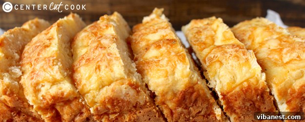 sliced-garlic-cheese-bread.jpg A freshly baked loaf of quick garlic cheese bread, sliced to reveal its soft, cheesy interior and golden crust.