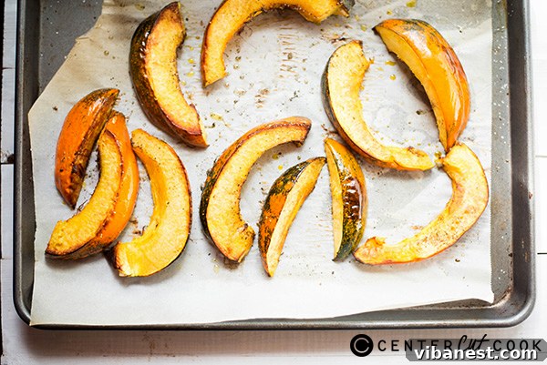 Acorn Squash Halves Ready for Roasting Close-up of freshly cut acorn squash halves, revealing the vibrant orange flesh and cavity
