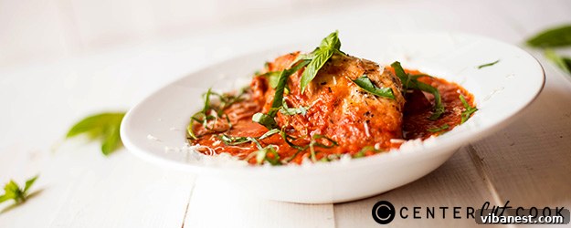 Delicious Slow Cooker Chicken Parmesan ready to serve, garnished with fresh basil