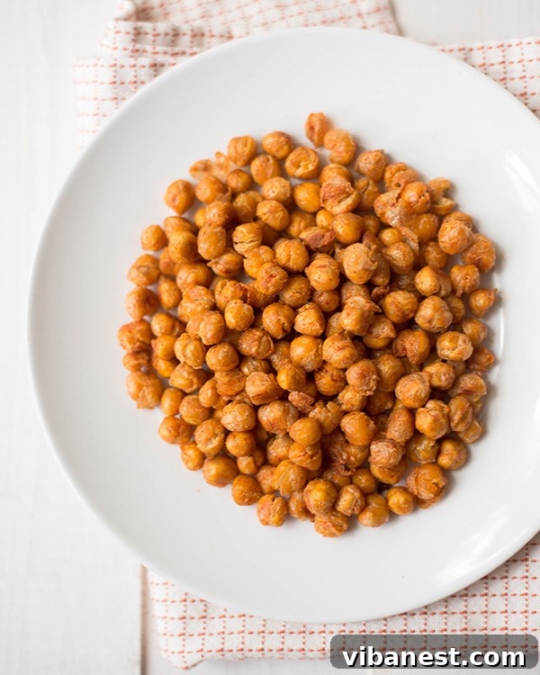 A close-up shot of perfectly seasoned roasted chickpeas in a rustic bowl
