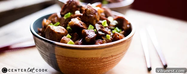 Final presentation of spicy chicken eggplant stir fry. A top-down view of the finished spicy chicken and eggplant stir fry in a large serving bowl, ready to be enjoyed.