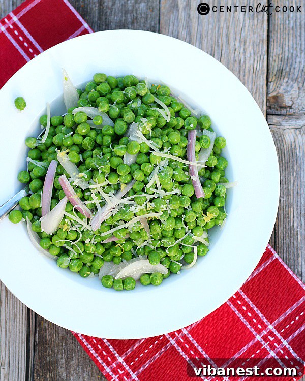Close-up of fluffy Parmesan Peas with Shallots and Lemon in a bowl