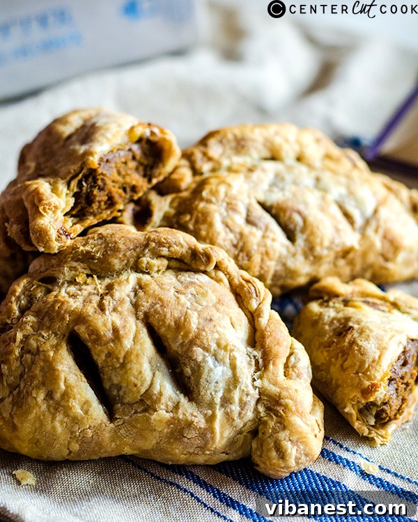 Perfectly Baked Pumpkin Hand Pie Close-up of a perfectly baked pumpkin hand pie, showcasing its golden crust and delicate fork-crimped edges, ready to be enjoyed.