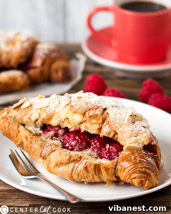 raspberry-frangipane-stuffed-croissants-4.jpg Close-up of a raspberry frangipane croissant, showing the rich filling and crisp topping.