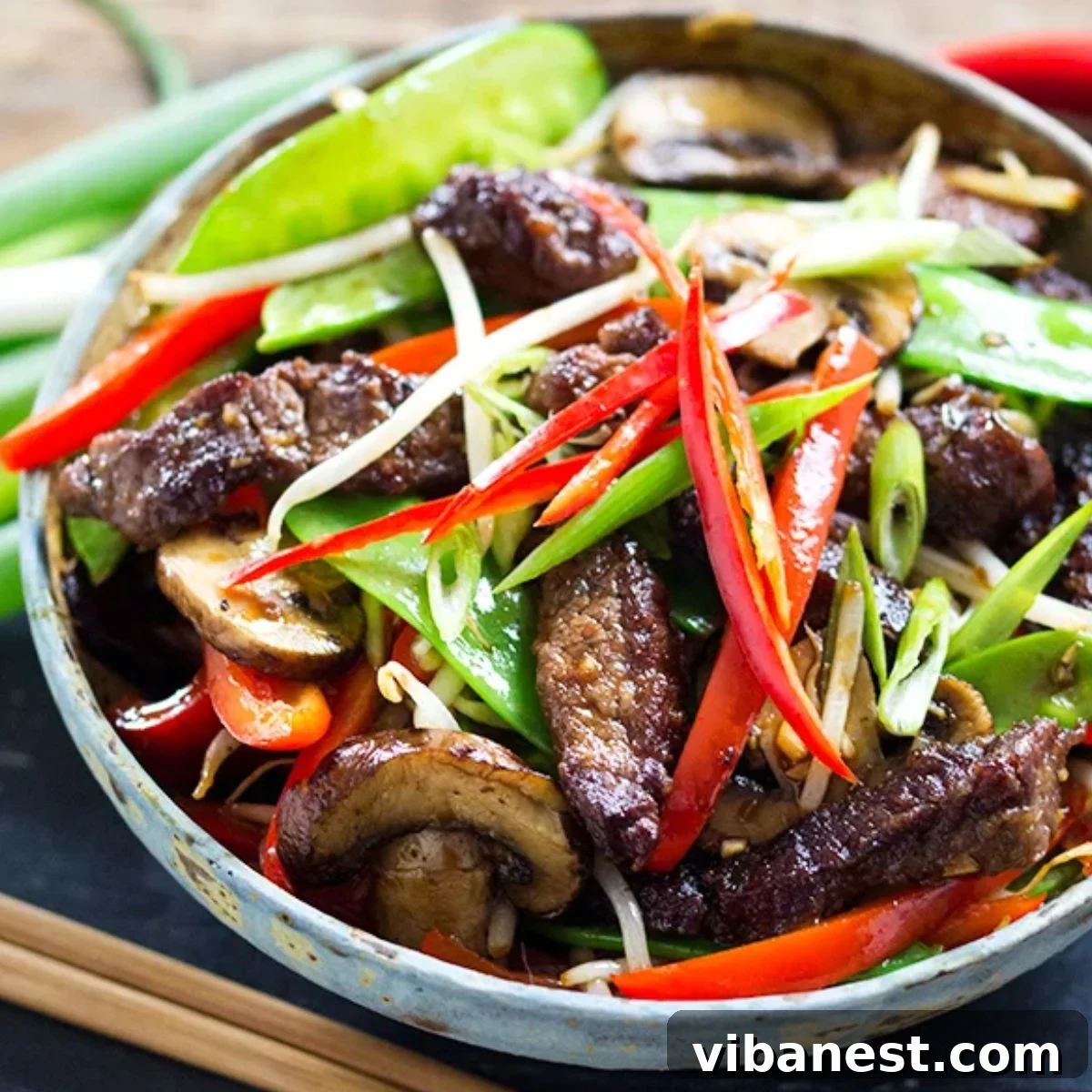 Sizzling Asian Beef & Vegetable Medley 2 Flavorful Asian Beef and Vegetable Stir Fry with vibrant sauce served over rice