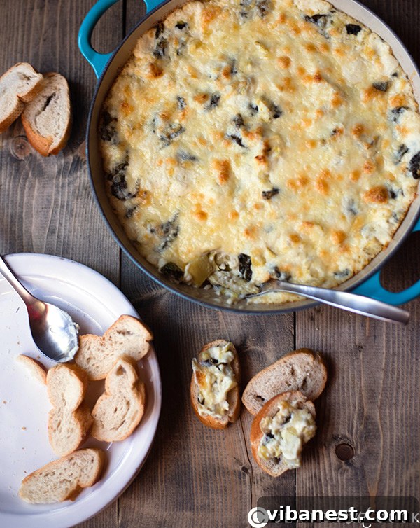 Close-up of creamy Four Cheese Spinach Artichoke Dip in a skillet