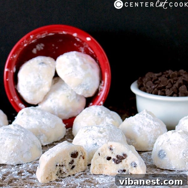 chocolate_chip_snowball_cookies3.jpg Close-up of golden-brown chocolate chip snowball cookies on a cooling rack before their second roll in powdered sugar.