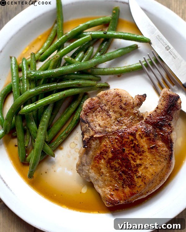 pan-roasted-pork-chops-ginger-green-beans-2.jpg Juicy pan-roasted pork chops with ginger green beans on a plate
