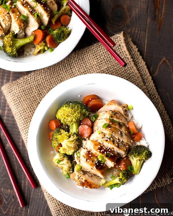 Savory Chicken Teriyaki Bowl Dinner Close-up of a chicken teriyaki bowl showing juicy chicken, vibrant broccoli florets, crisp carrot slices, and fluffy brown rice, ready to be enjoyed