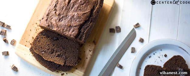 Delicious slice of chocolate butternut squash bread with whole loaf in background