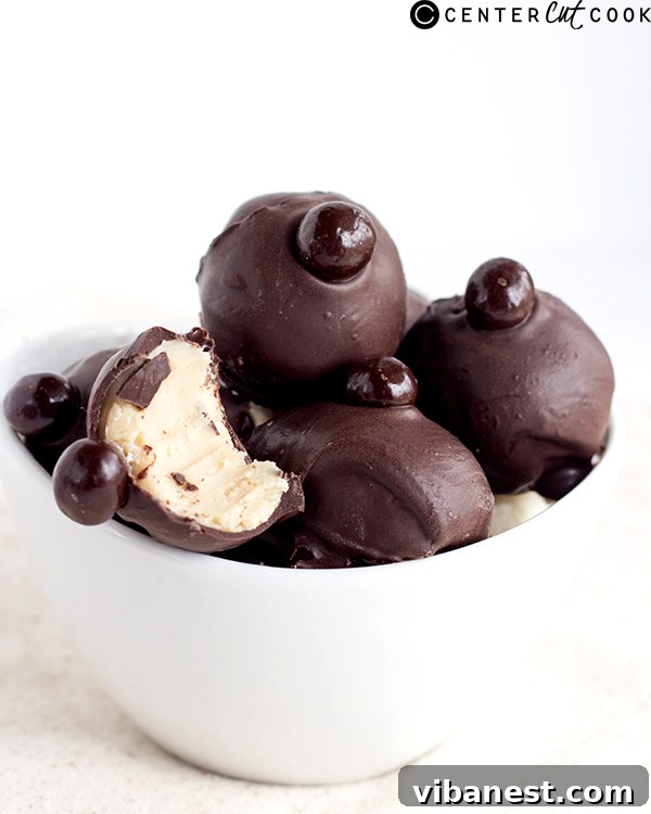 A batch of freshly rolled Eggnog Latte Truffles before dipping, showing their creamy, light-colored ganache centers.