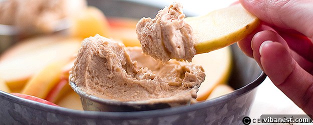 Delicious and creamy peanut butter fruit dip served with fresh apple slices, garnished with nuts