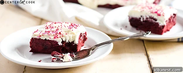 Delicious red velvet sugar cookie bars topped with cream cheese frosting, ready to be served.