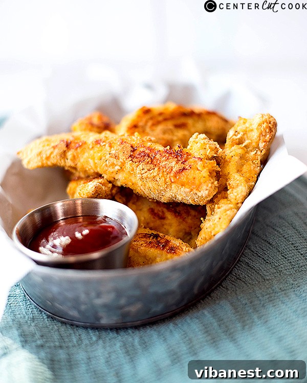 Close-up of golden Parmesan baked chicken strips
