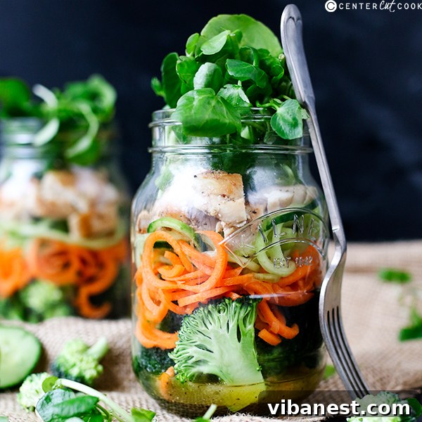 how-to-make-a-mason-jar-salad-3.jpg A mason jar salad being poured out into a white bowl