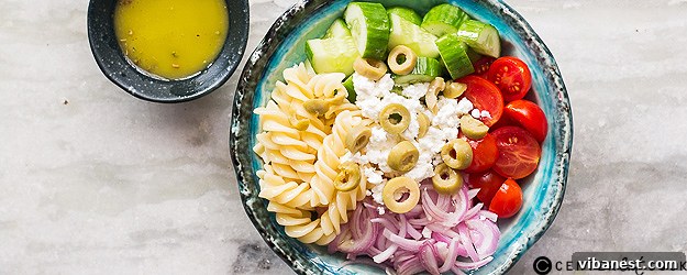 Vibrant Greek pasta salad with feta cheese and fresh vegetables
