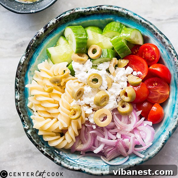 Greek Pasta Salad Final Dish Generous serving of Greek pasta salad in a white bowl