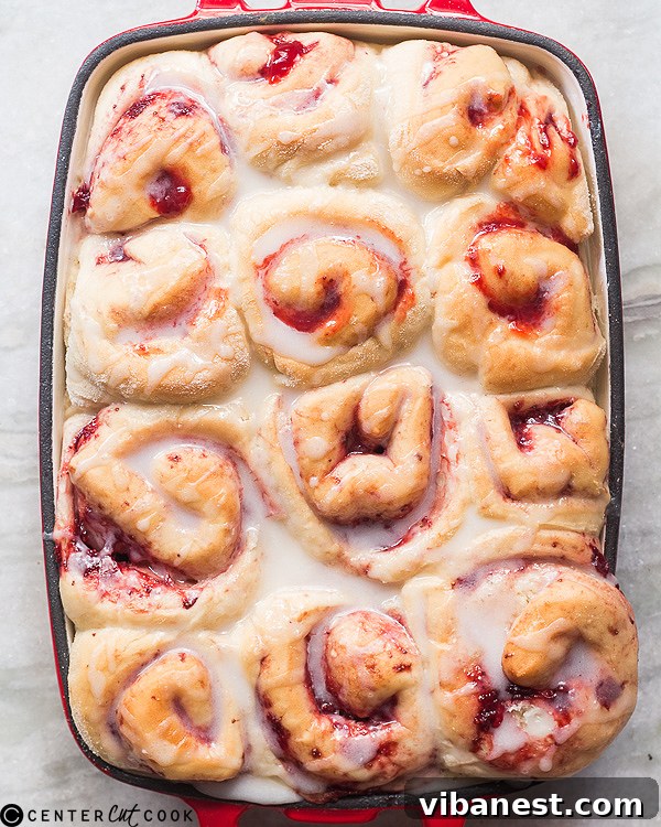 Close-up of freshly baked strawberry rolls cooling, showcasing the vibrant filling and soft texture