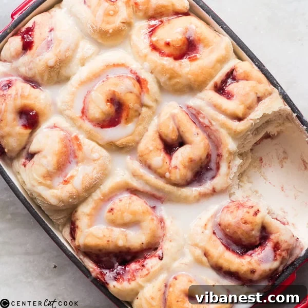 Baked strawberry rolls drizzled with a rich rum glaze, perfectly golden and ready to serve