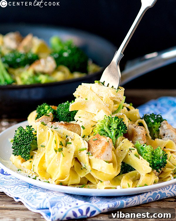 chicken-broccoli-alfredo-2.jpg A creamy bowl of Chicken and Broccoli Alfredo pasta topped with fresh Parmesan and parsley.
