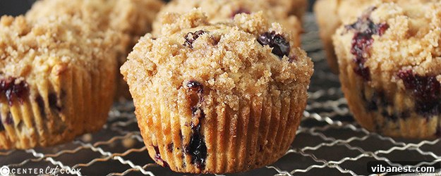 Freshly Baked Blueberry Crumb Muffins Batch of blueberry crumb muffins cooling on a wire rack