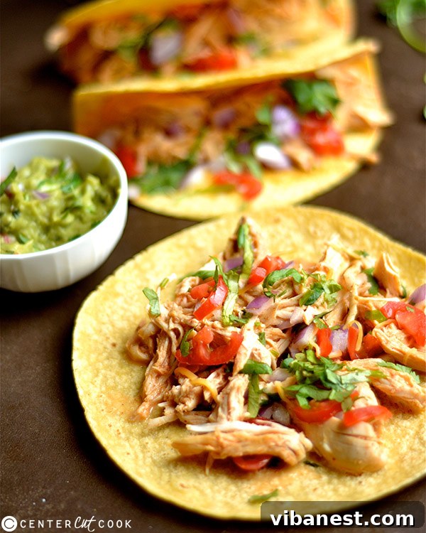 Assortment of fresh taco toppings including avocado, tomato, onion, and cilantro