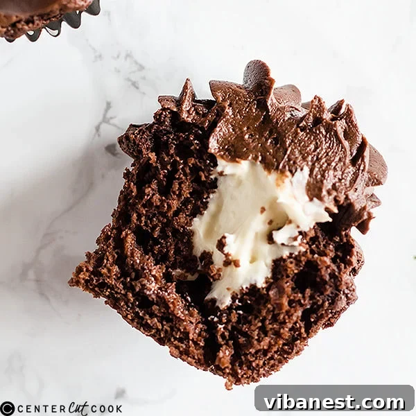 A batch of freshly baked and frosted Chocolate Cheesecake Cupcakes